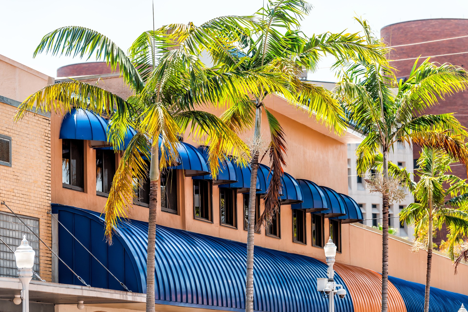 Fort Myers city town during sunny day in Florida gulf of mexico coast shopping restaurants and closeup of spanish blue architecture