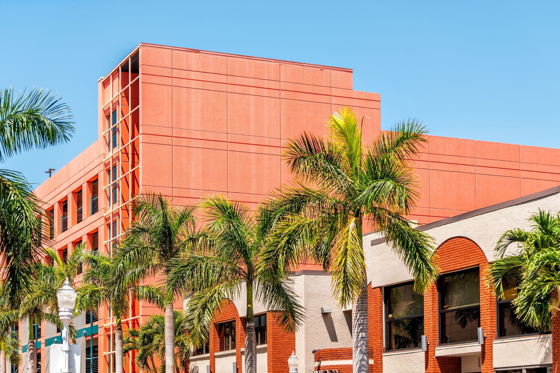 Fort Myers city during sunny day in Florida gulf of mexico coast shopping restaurants and closeup of spanish orange architecture