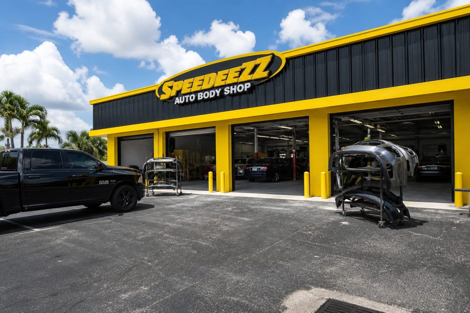 Auto Body Shop Serving Estero, FL Auto Body Shop Serving Estero, FL — Speedeezz Auto Finish auto body shop with yellow bay doors in Fort Myers